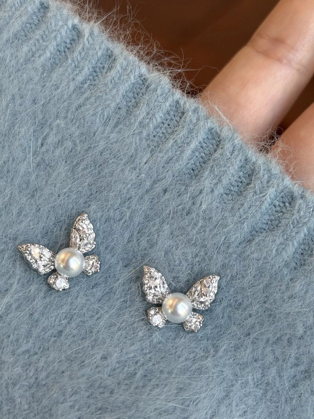 Butterfly Pearl Stud Earrings by Shopimist featuring elegant white pearl studs with butterfly-shaped backings on a white background.