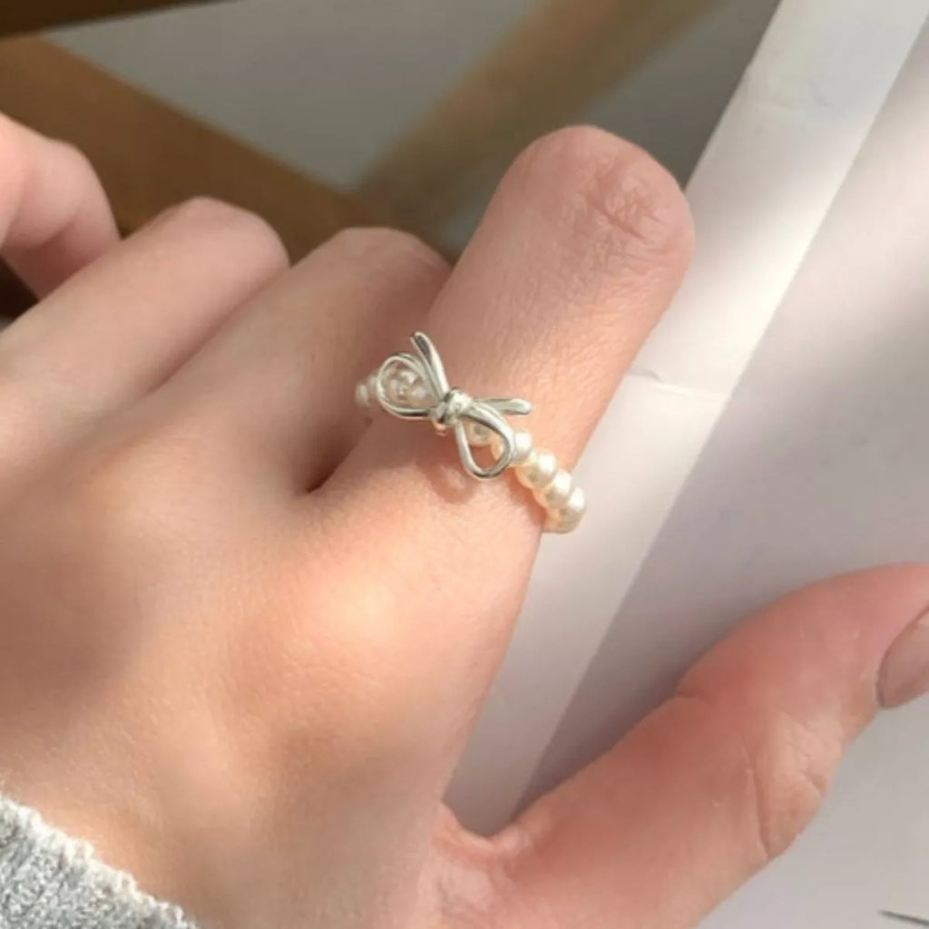 Shopimist Bow Pearl Beaded Ring featuring delicate pearl beads and a charming bow design, perfect for elegant jewelry styling.