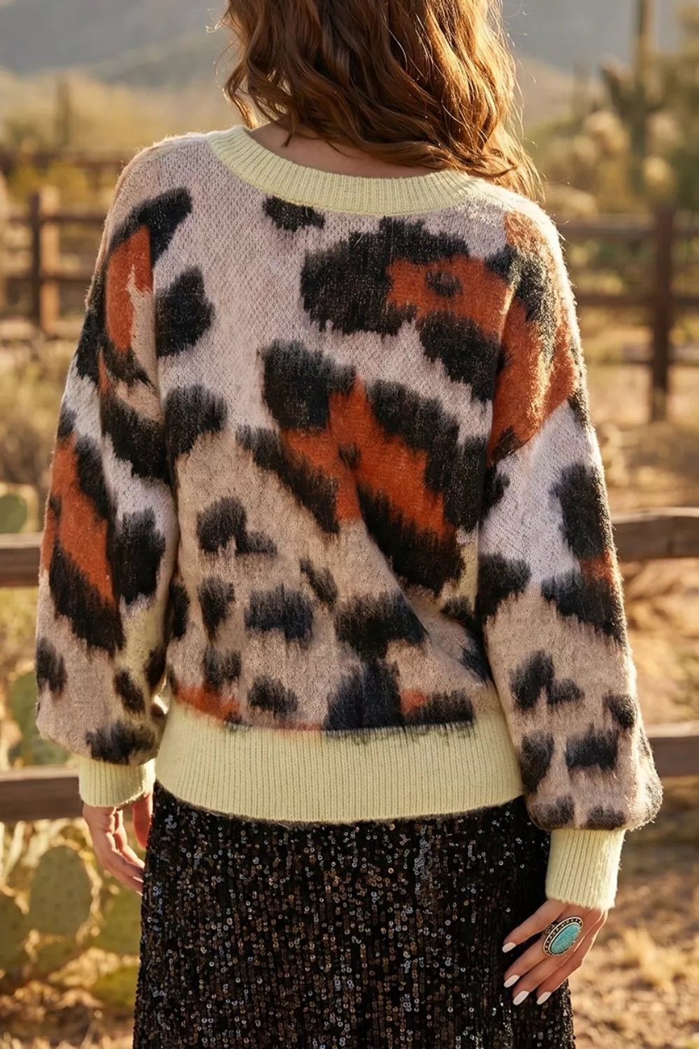 Leopard print drop shoulder long sleeve sweater with round neck by Trendsi, featuring a cozy, stylish design and comfortable fit.