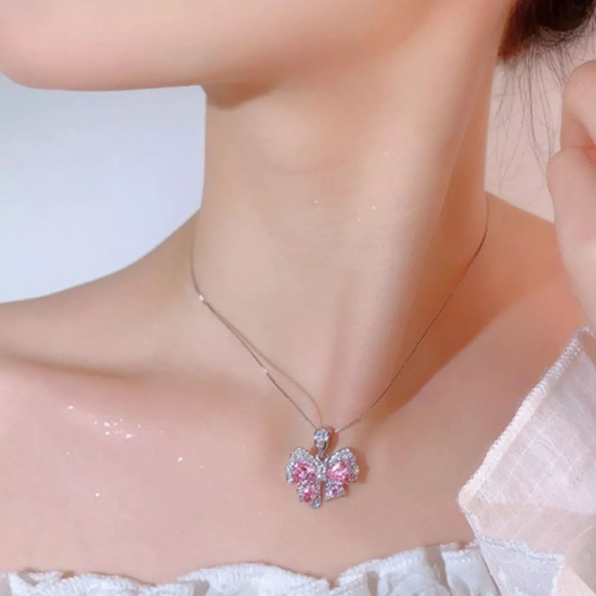 Plush Fashion Hub zircon bow pendant necklace with sparkling stones and silver chain, elegant jewelry for women.