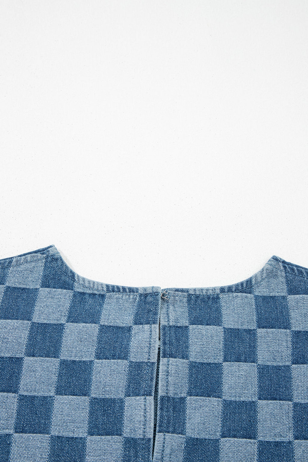 Threaded Pear Jessie Hem checkered mini dress hanging on a hanger, showcasing its stylish pattern and design details.