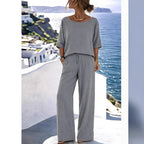 Women's FitiqueFit resort set with short sleeve top and wide-leg pants, displayed on a hanger against a neutral background.