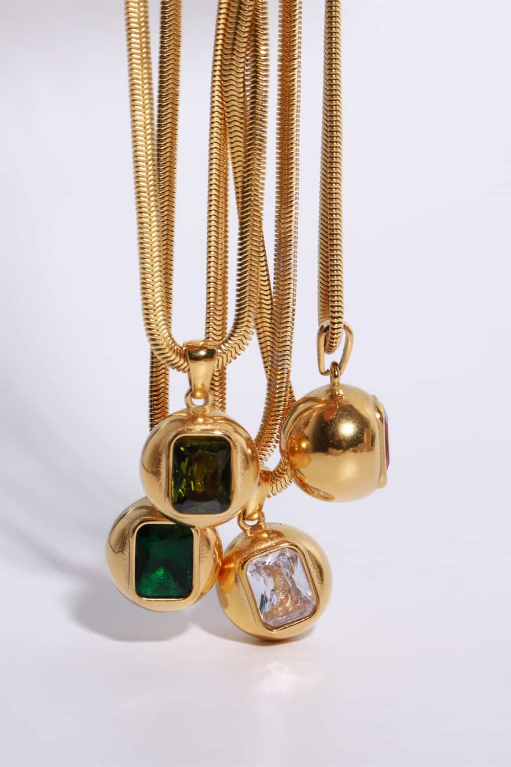 Zircon 18K gold-plated geometrical shape pendant necklace with a sleek modern design, featuring a delicate chain and sparkling accents.