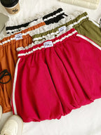 Lace trim elastic waist mini skirt from Trendsi, showing soft fabric with delicate lace detailing and a fitted waistband.