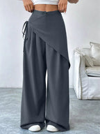 Asymmetrical wrap wide-leg pants from Plush Fashion Hub, featuring a stylish design and flowing silhouette.