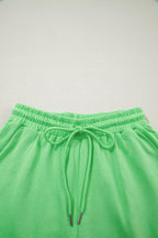 Pair of trendy solid color puffy loose drawstring shorts and rings from Trendsi, shown in a stylish 2-piece outfit.