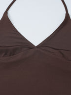 Women's halter neck slim fit cami top by Trendsi, sleeveless stretch tank with fitted design, shown on a model.