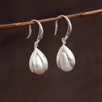 Sterling silver drop earrings featuring elegant, polished design with hooks, crafted by Shopimist for stylish wear.