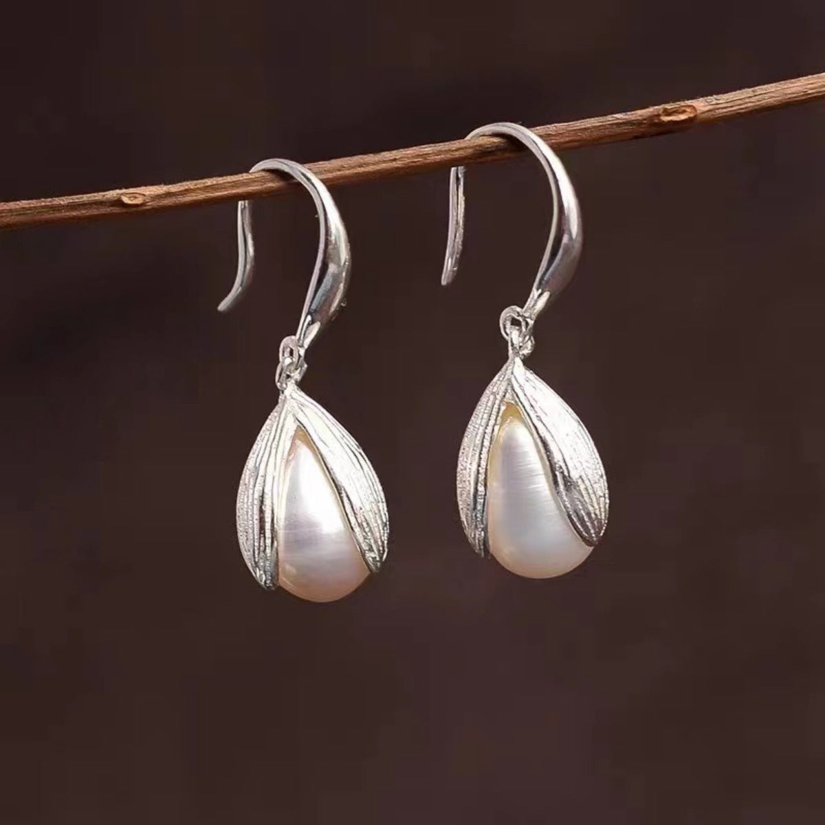 Sterling silver drop earrings featuring elegant, polished design with hooks, crafted by Shopimist for stylish wear.