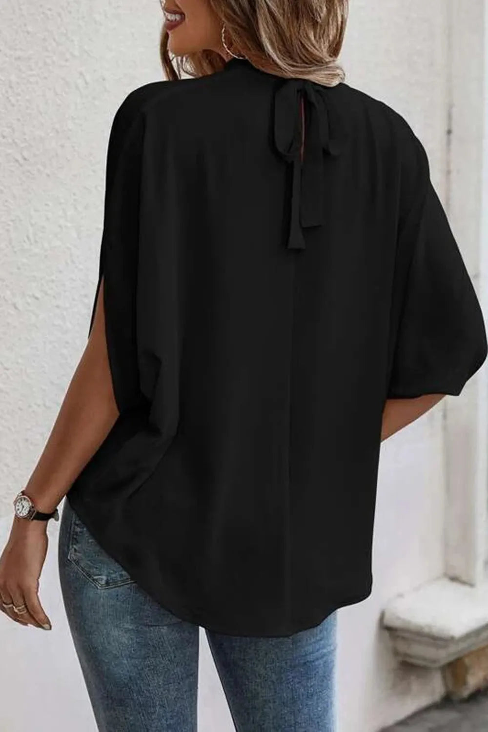 Plush Fashion Hub elegant tie-back half-sleeve blouse with side slit, featuring a stylish and comfortable top design.