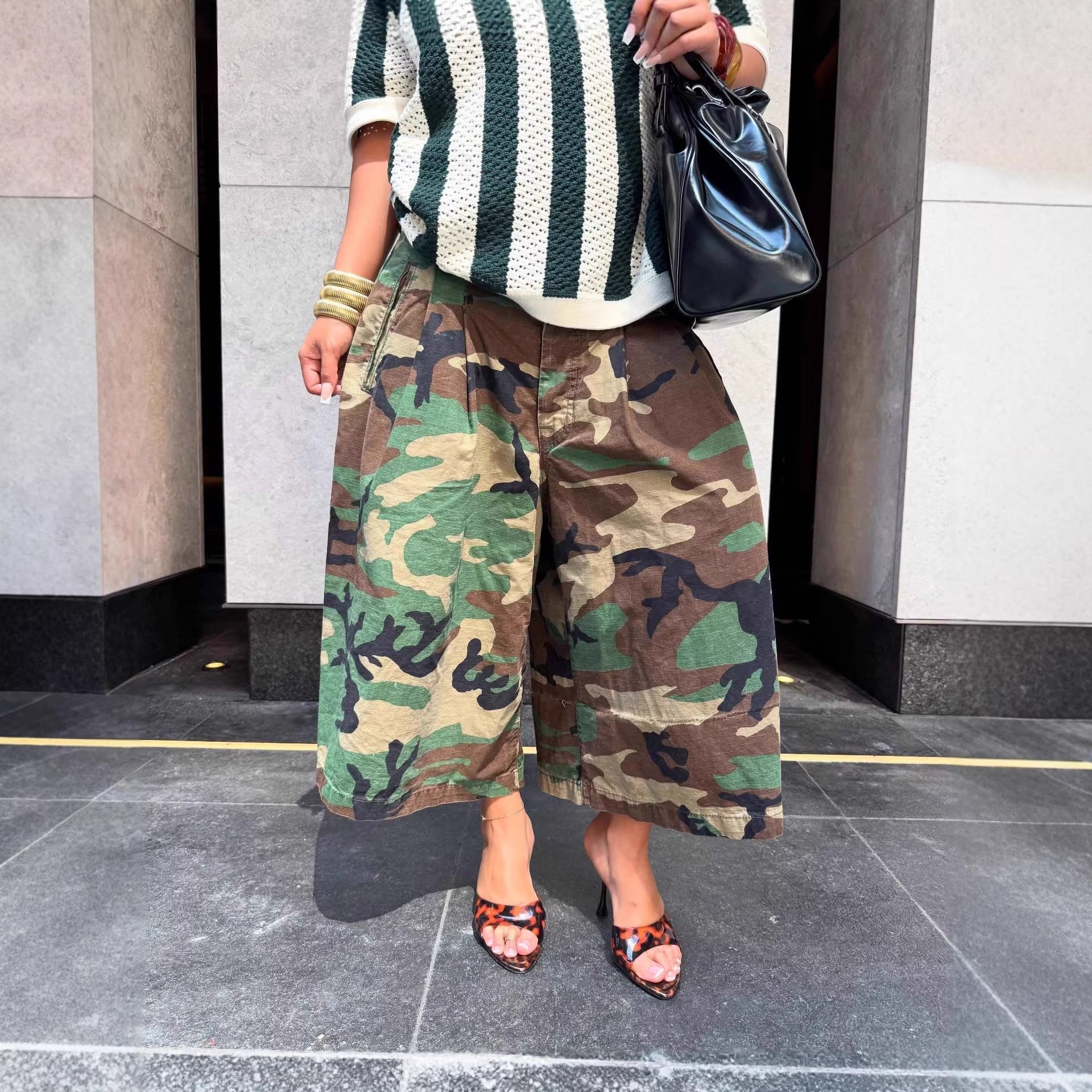 Women's wide-leg cargo pants by Plush Fashion Hub featuring zipper and button details, shown in a casual style.