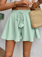 Flowy drawstring waist romper shorts from Trendsi, featuring a relaxed fit and lightweight fabric, ideal for casual summer wear.