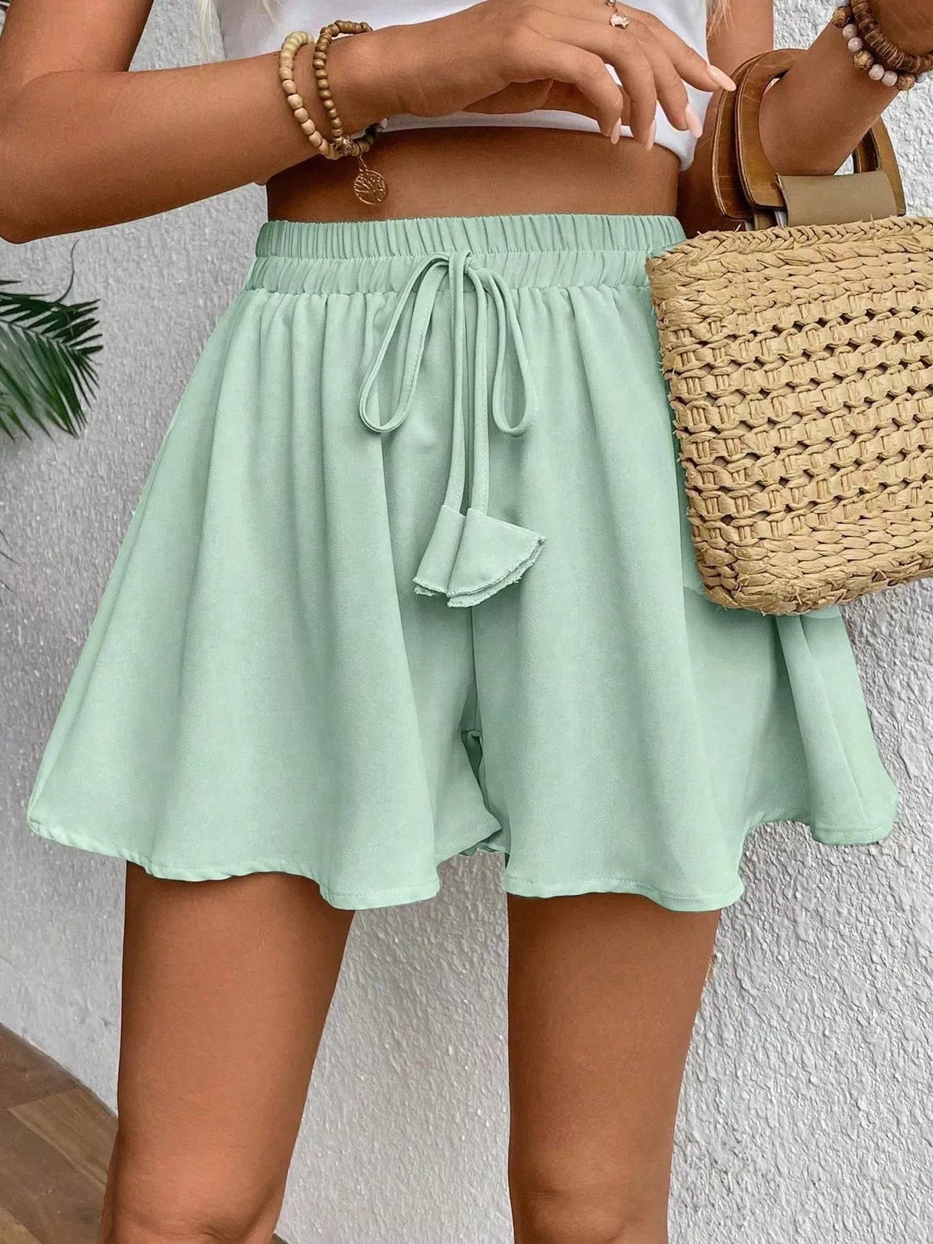 Flowy drawstring waist romper shorts from Trendsi, featuring a relaxed fit and lightweight fabric, ideal for casual summer wear.