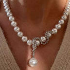 Elegant zircon pearl necklace featuring lustrous pearls and sparkling zircon accents, styled on a delicate chain.