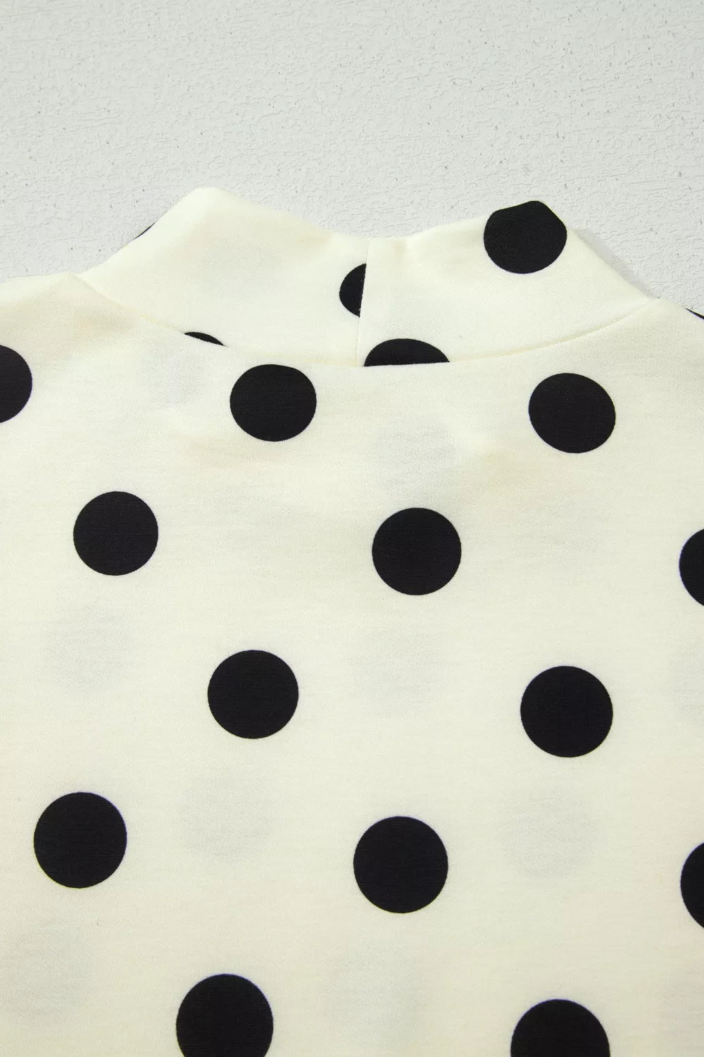 Polka dot print high neck dolman top by Plush Fashion Hub, featuring a relaxed fit and stylish design.