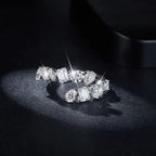 Sterling silver bypass ring featuring a 2.6 carat moissanite gemstone, designed with elegant, flowing curves.