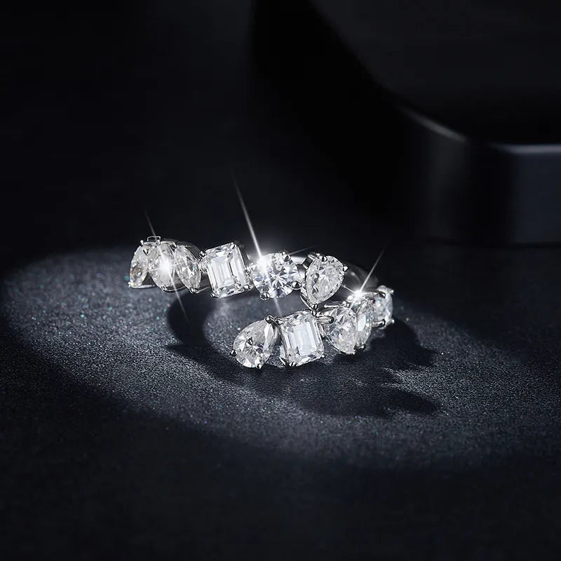 Sterling silver bypass ring featuring a 2.6 carat moissanite gemstone, designed with elegant, flowing curves.