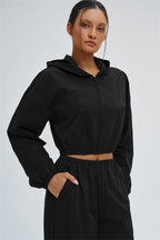 A Fitglutes Activewear UV protection crop hoodie in black, featuring a fitted design, long sleeves, and a hood for active gym workouts.