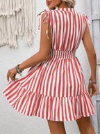 Women's striped smocked summer dress with ruffle hem, featuring a fitted bodice and breezy, casual style by Trendsi.