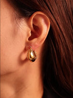 Silver-tone 18K gold-plated stainless steel huggie earrings with a sleek, minimalist design for everyday wear.