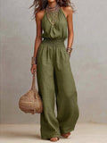 Women's black halter-neck backless wide-leg jumpsuit by Plush Fashion Hub, stylish streetwear with a solid color design.