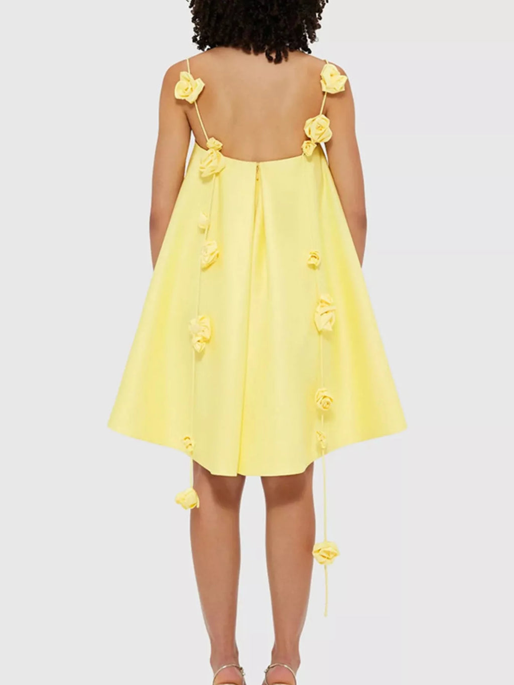 Floral strap mini A-line dress by Trendsi featuring a fitted bodice, flared skirt, and vibrant floral pattern.