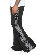 Plus size men's full-length pants with side snap buttons by Trendsi, shown in a neutral color, detail of waistband and snap closures.
