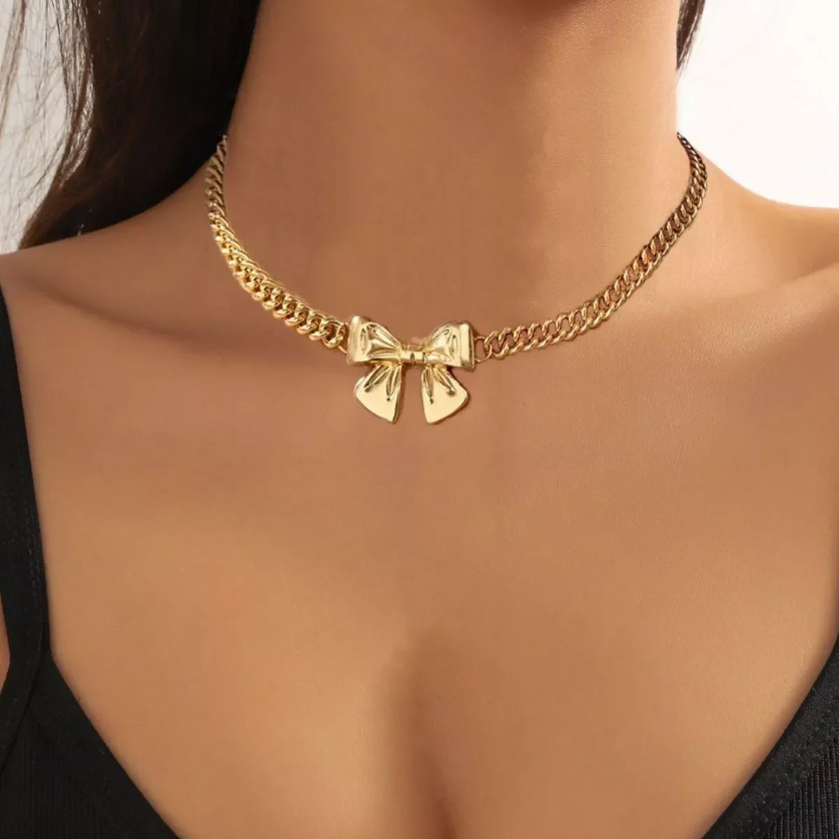 18K gold-plated bowknot chain necklace by Simply Love, featuring a delicate and elegant design with a shiny finish.