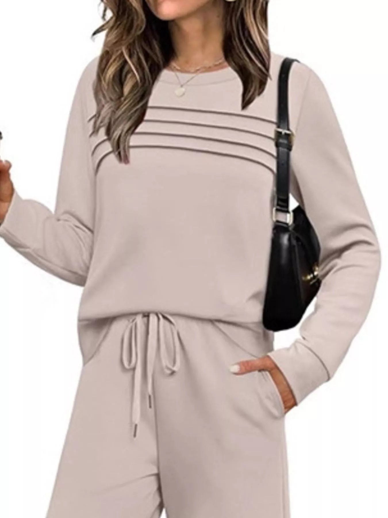 Plus size casual long sleeve crewneck top and drawstring pants set by Trendsi, featuring comfortable fabric and relaxed fit.
