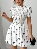 Shopimist smocked bow print short sleeve dress featuring a feminine design with a fitted waist and playful bow details.