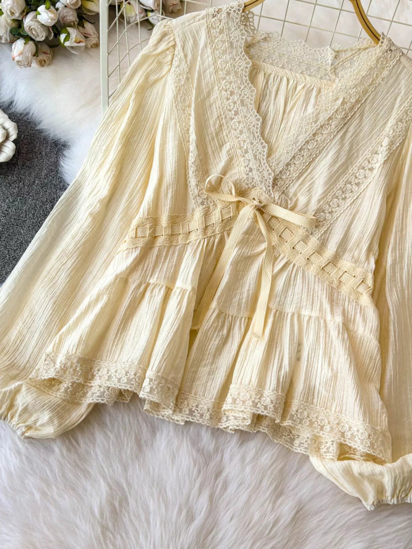 Lace detail v-neck blouse dress by Trendsi featuring delicate lace accents and a stylish V-neck design.