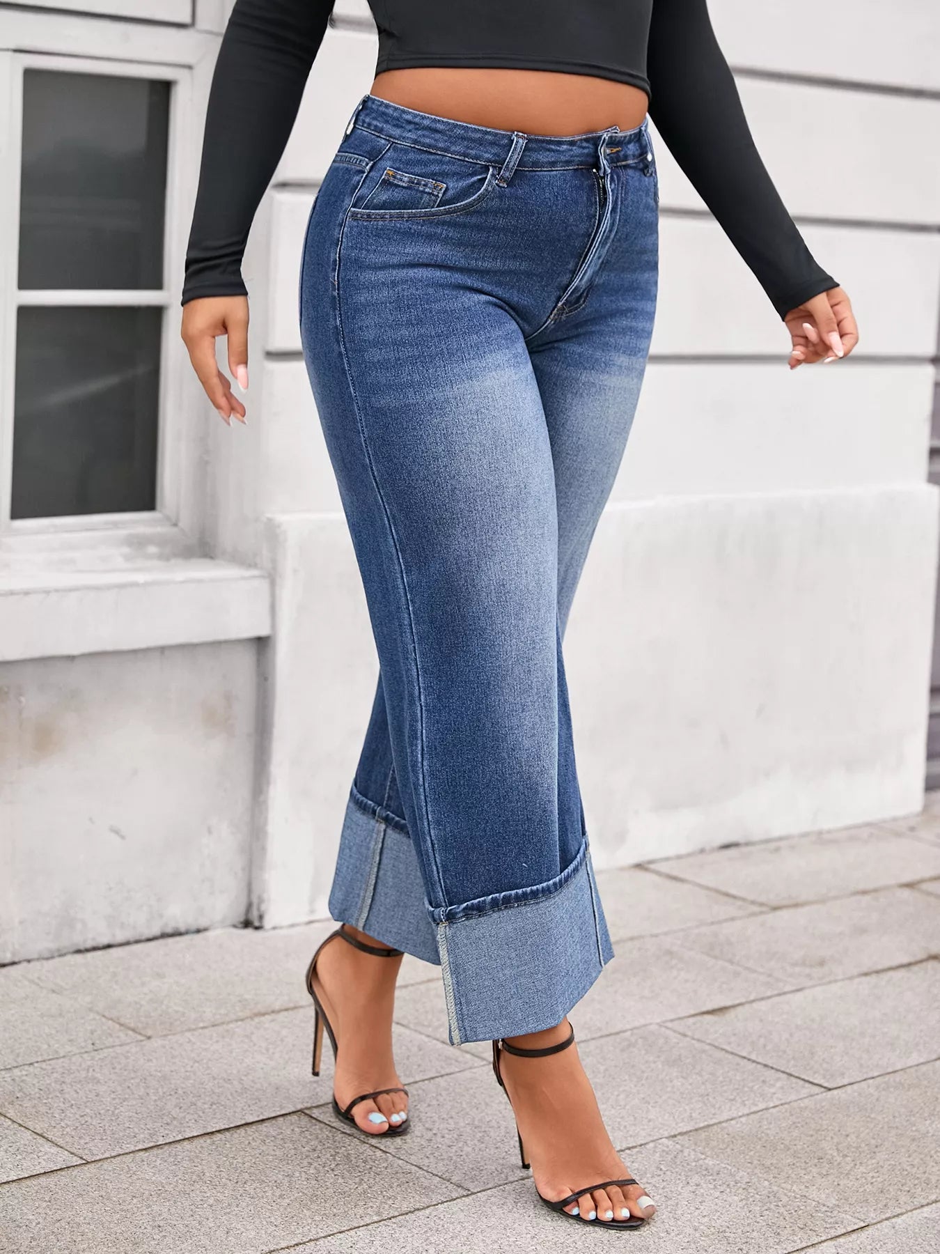 Plus size high waist cuffed wide leg jeans from Shopimist, showing the denim's relaxed fit and cuffed hem detail.