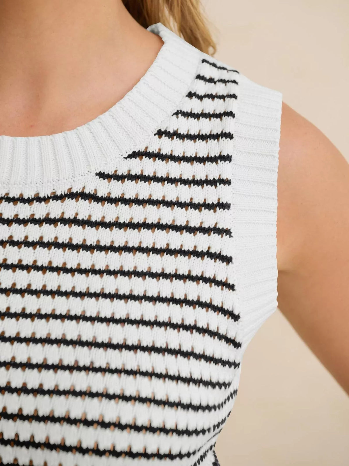 Striped knit sweater vest by Plush Fashion Hub featuring a cozy design and colorful horizontal stripes on soft fabric.
