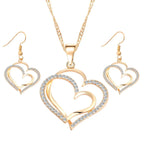 Double heart earrings and necklace wedding set featuring silver-tone jewelry with romantic heart-shaped designs.