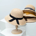 Women's straw sun hat with wide brim and ribbon detail, stylish summer accessory by Plush Fashion Hub