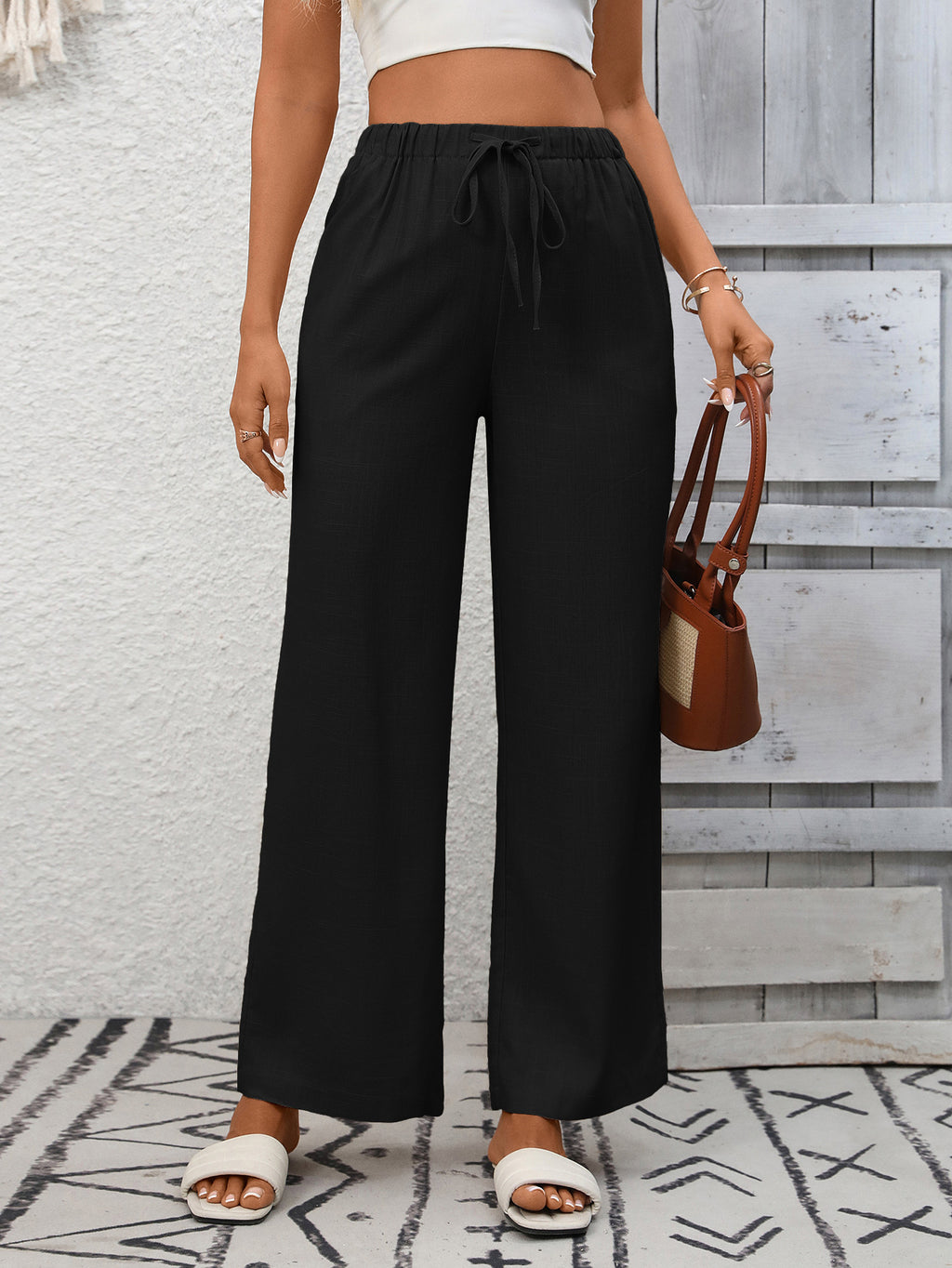 Women's high-waisted wide-leg drawstring pants in soft breathable viscose, shown in a relaxed fit with a drawstring waist.