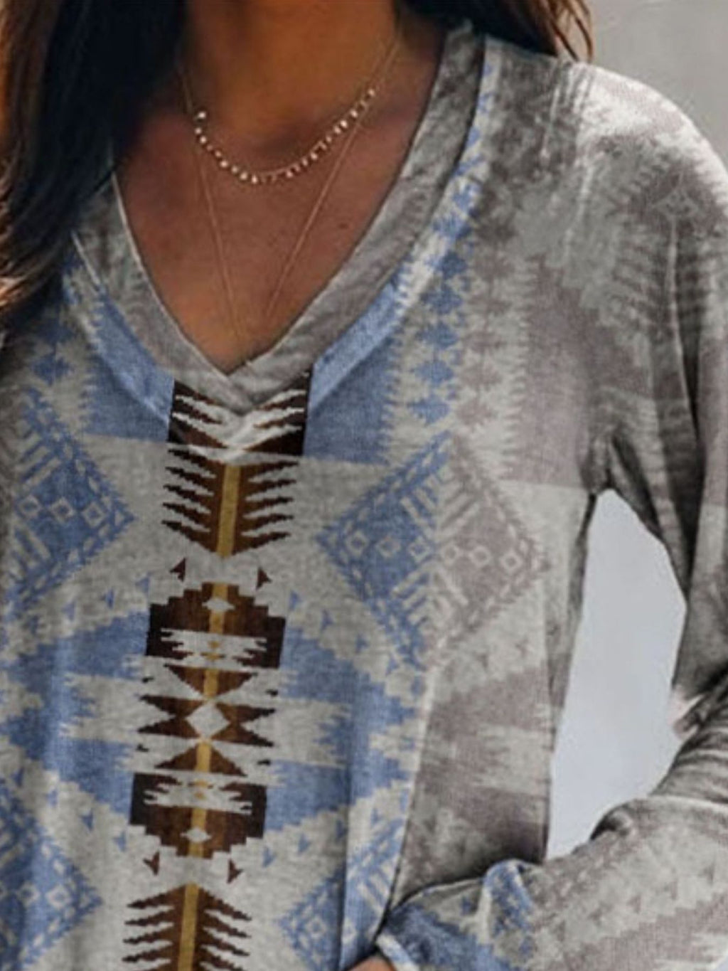 Plus size Geometric print V-neck long sleeve T-shirt by Trendsi, featuring a casual style and comfortable fit.