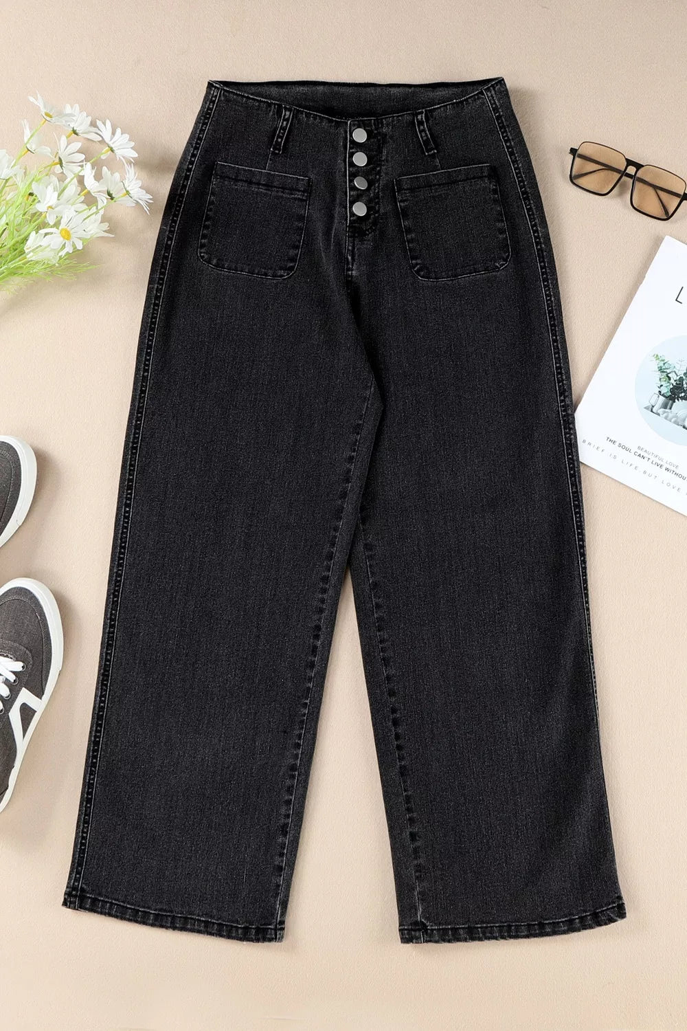 High-waisted button-fly wide-leg jeans from Trendsi featuring classic denim fabric and relaxed fit, displayed on a hanger.