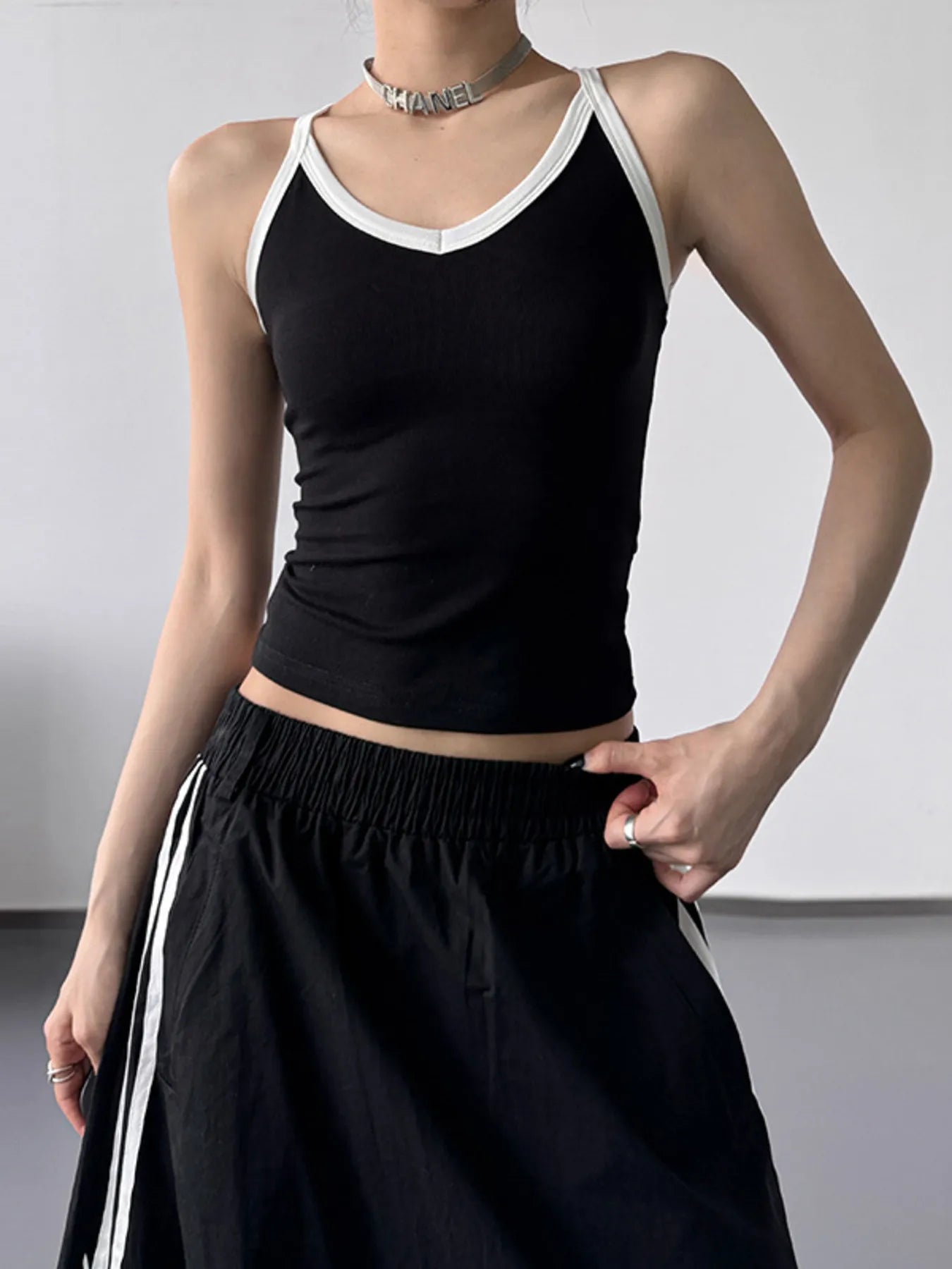 Contrast trim cami top from Trendsi featuring a sleek design with contrasting edging, perfect for stylish casual wear.