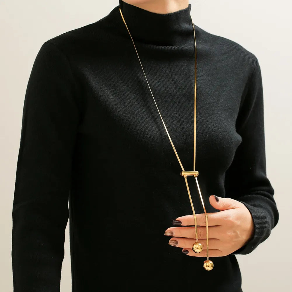 18K gold-plated titanium steel hollow bead necklace with smooth, shiny beads, showcasing elegant jewelry design.