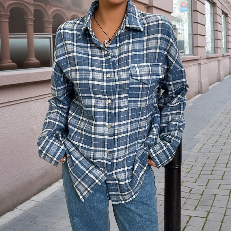 Oversized blue and white plaid flannel shirt with a chest pocket, collar, and silver-toned buttons.