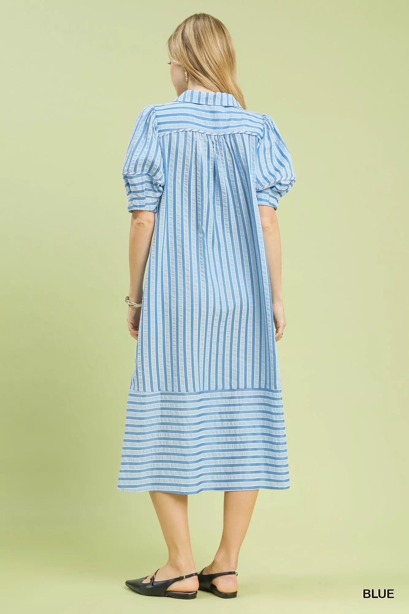 Umgee striped puff sleeve midi dress displayed on a hanger, featuring a fitted bodice and flowing skirt in a stylish striped pattern.