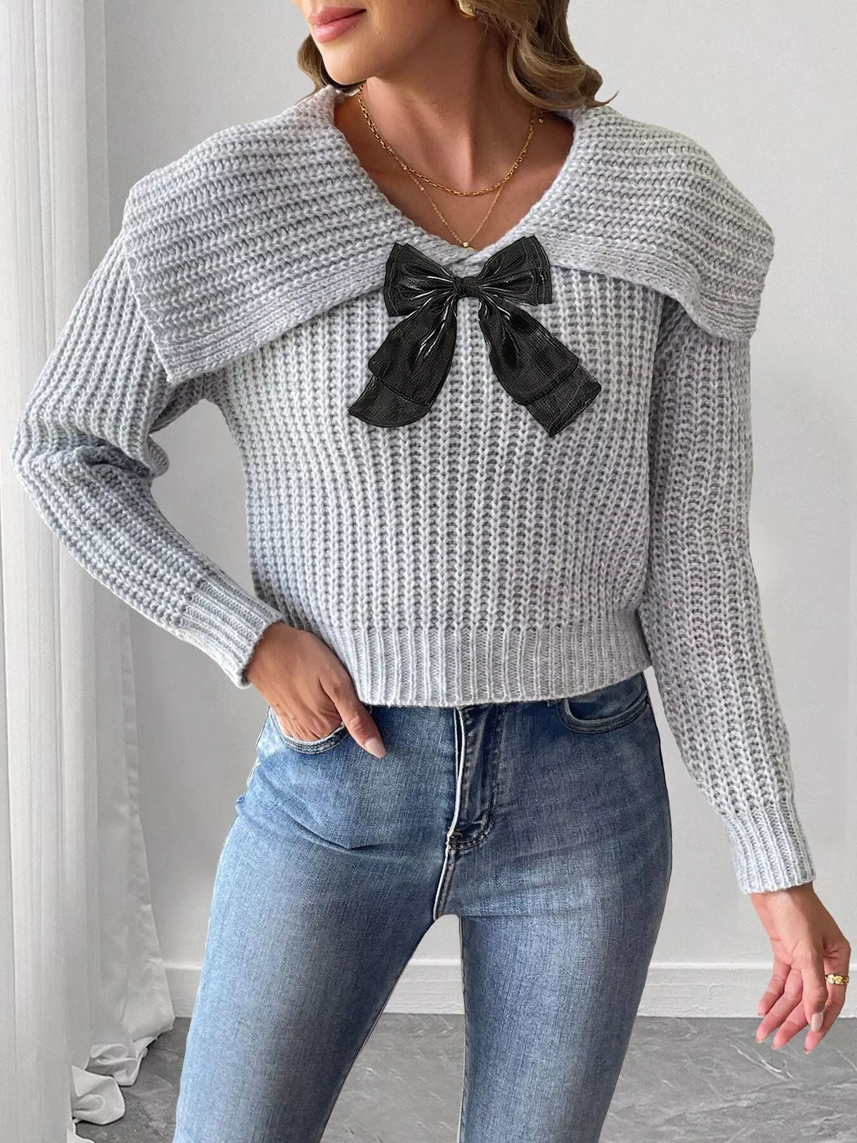 Contrast bow long sleeve sweater paired with a stylish skirt, featuring a cozy design and trendy details from Trendsi.