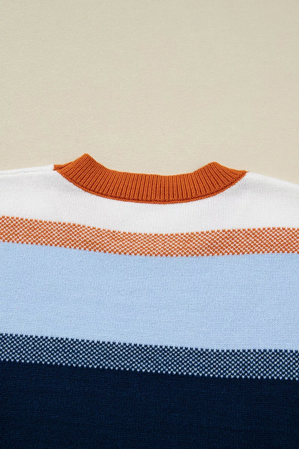 Color block round neck tunic sweater by Trendsi, featuring bold color sections and a cozy, relaxed fit.