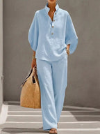 Plus size women's two-piece dress set with button details and 3/4 sleeves, featuring a stylish top and matching pants.