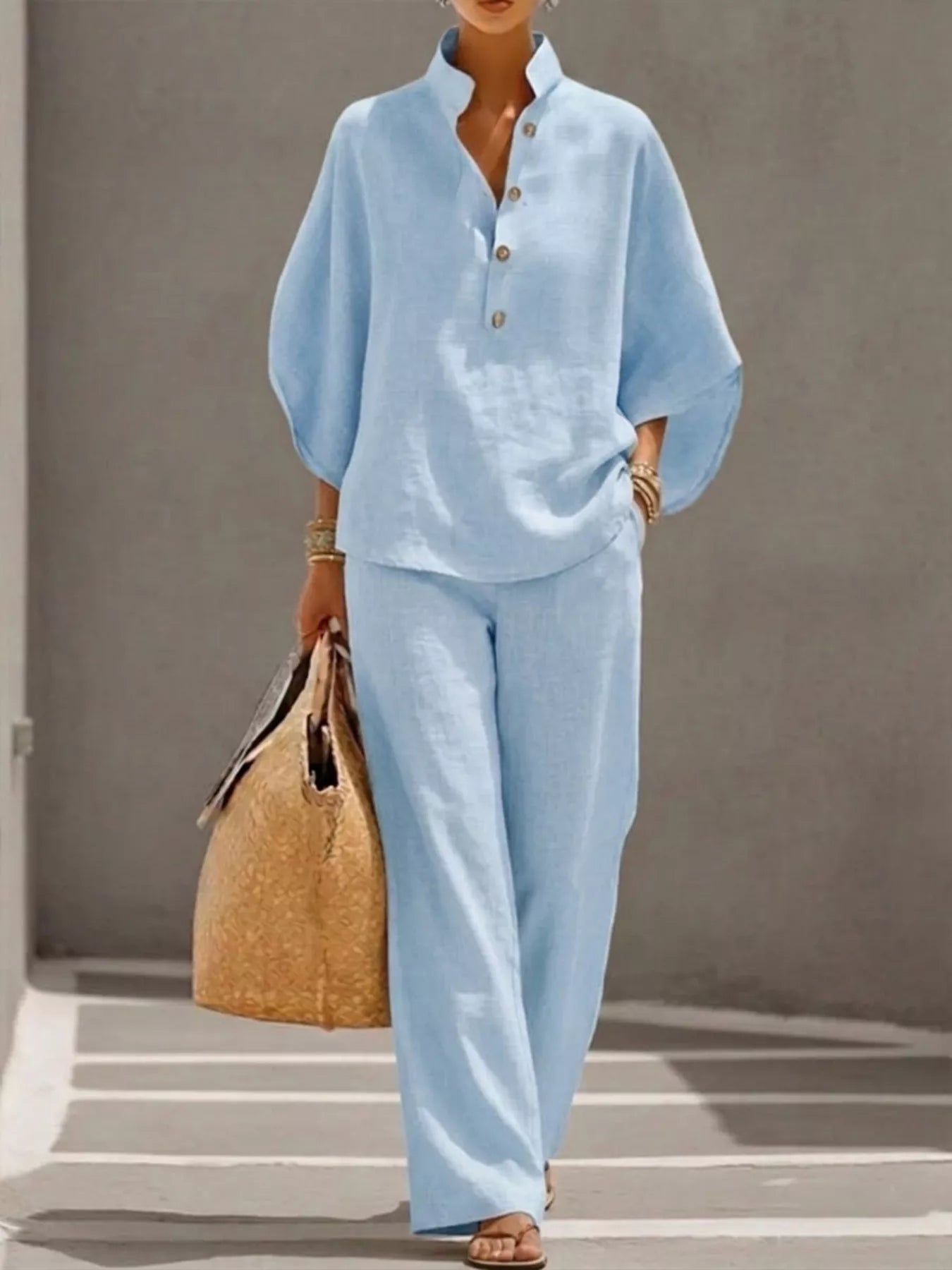 Plus size women's two-piece dress set with button details and 3/4 sleeves, featuring a stylish top and matching pants.