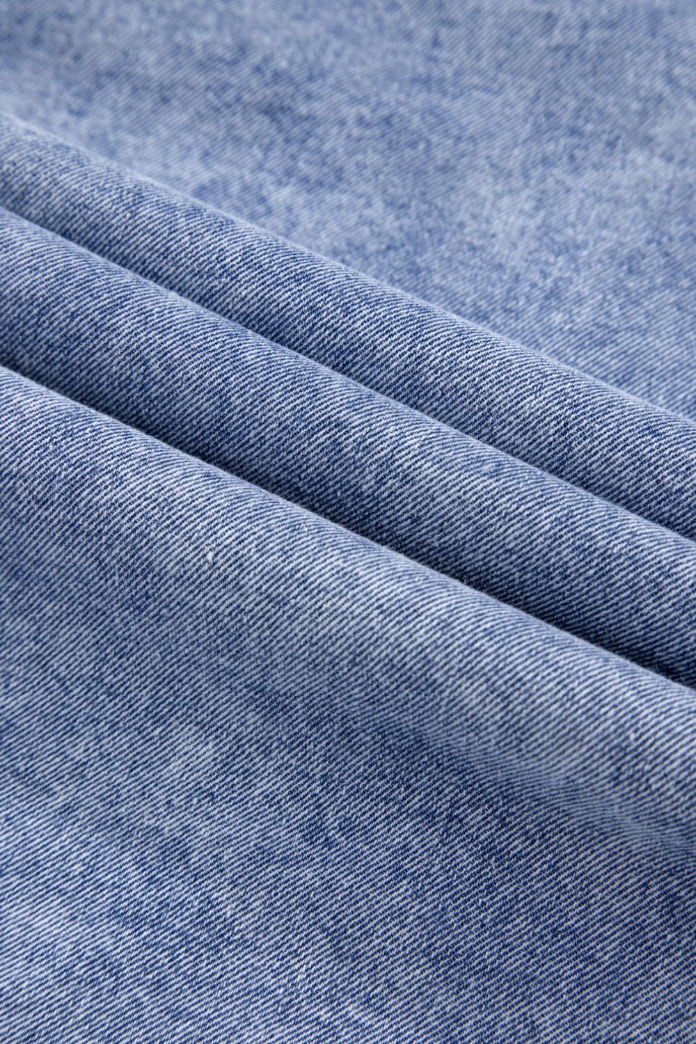 VYSN raw hem button-down long sleeve denim dress displayed on a hanger, showcasing the casual style and raw hem detail.