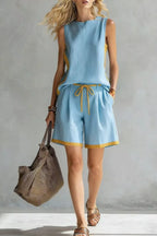 Contrast trim sleeveless tank and shorts loungewear set by Trendsi, featuring a relaxed fit and stylish design in soft fabric.