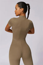 Fitglutes activewear Mia Belle jumpsuit in black, fitted athletic jumpsuit with sleeveless design and side pockets for workout wear.