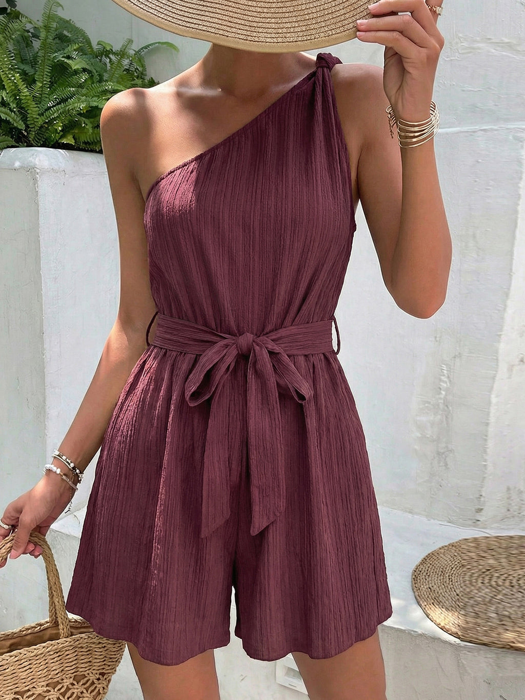 Elegant one-shoulder tie-waist romper in premium polyester, stylish summer jumpsuit by Plush Fashion Hub, shown on model.